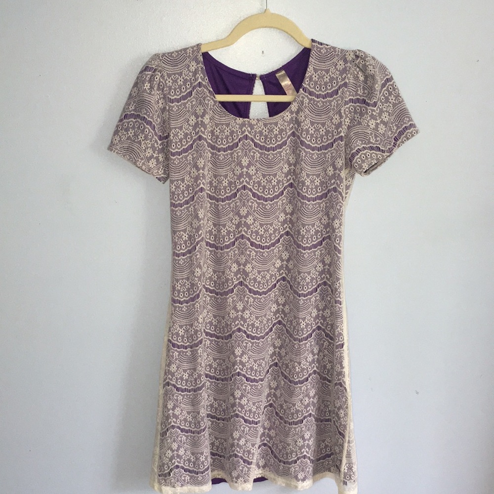 Purple dress with white lace over. Knee-length. Button up back.